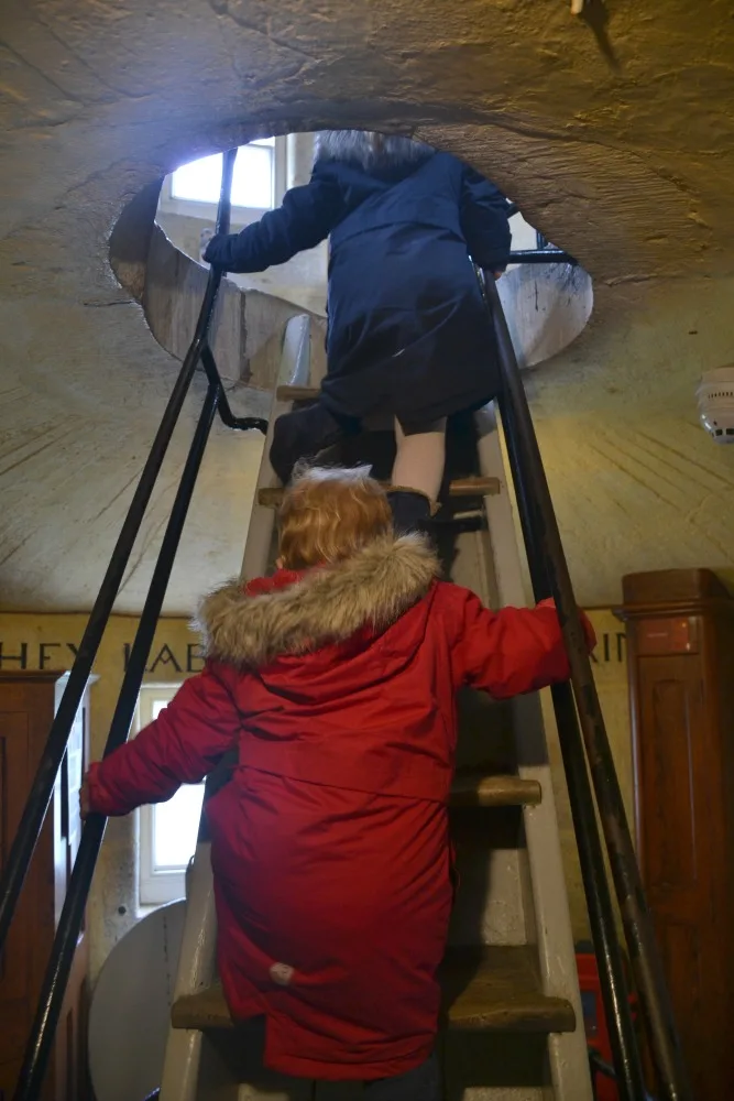 Children climbing ladder in lighthouse in Plymouth