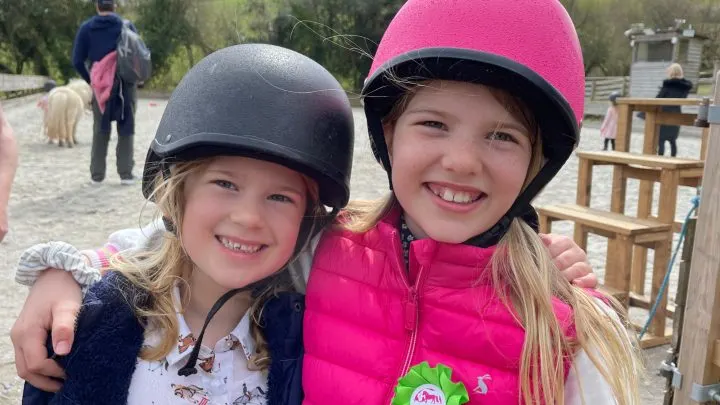 Girls wearing riding helmets