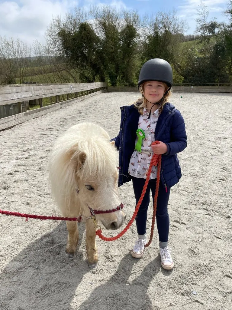 Girl walking pony on a lead