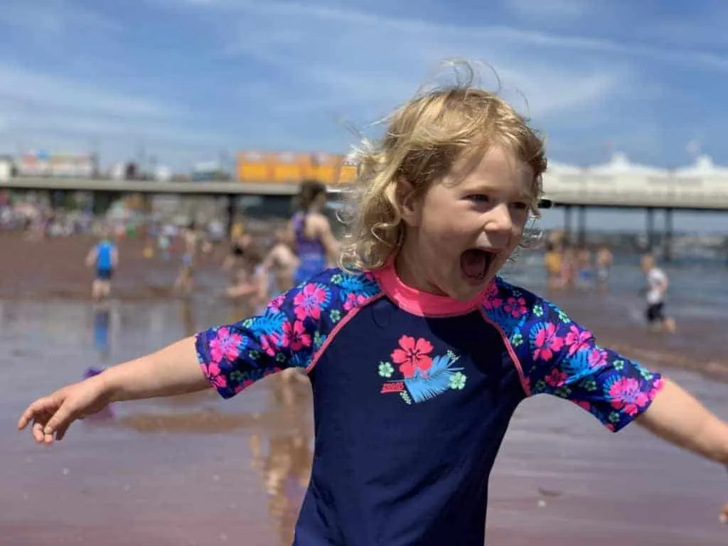 Child playing on Paignton beach in Devon