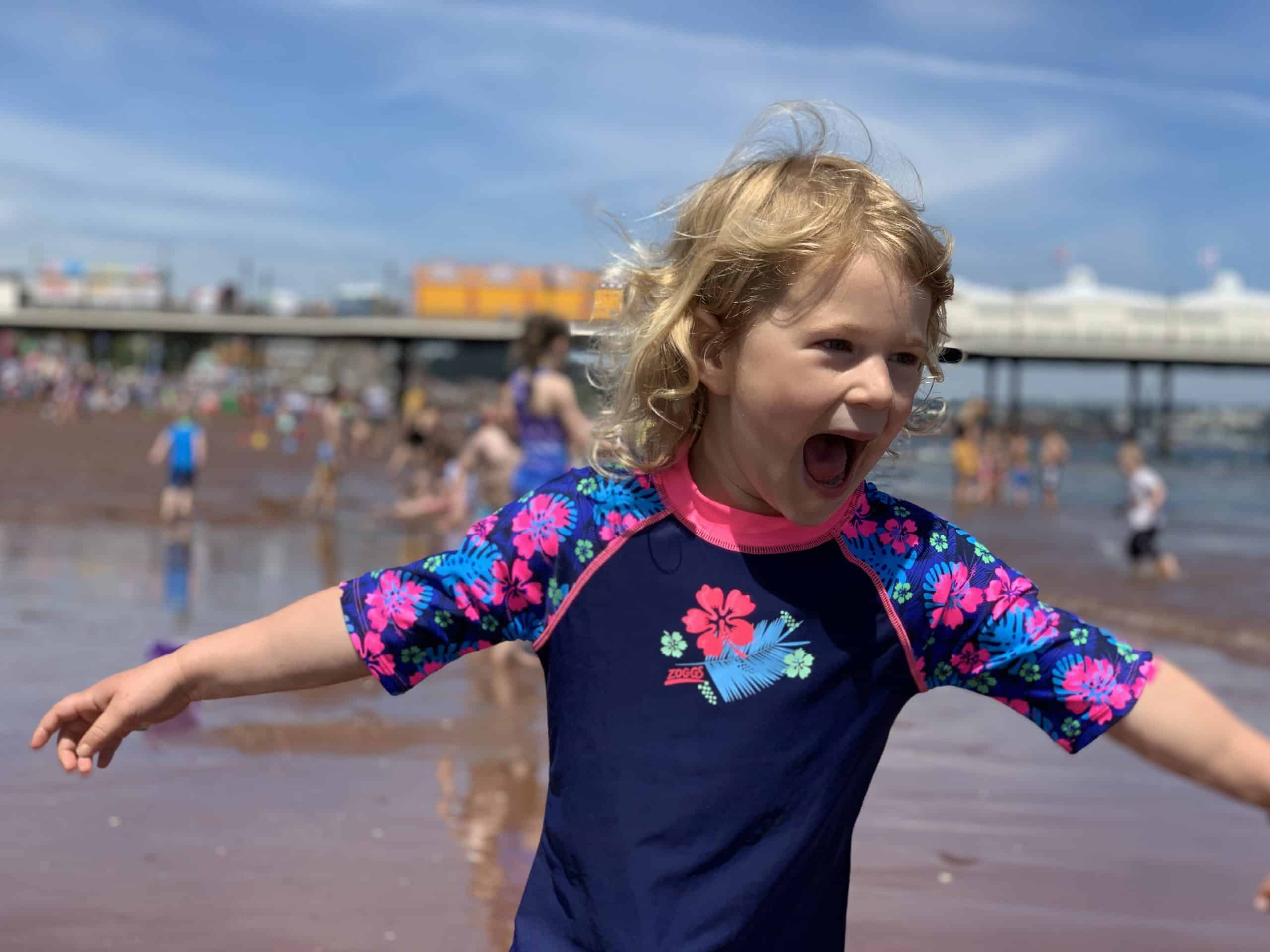 Child playing on Paignton beach in Devon