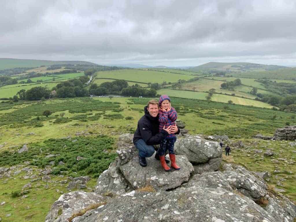 Father and daughter on top of Hound Tor in Dartmouth