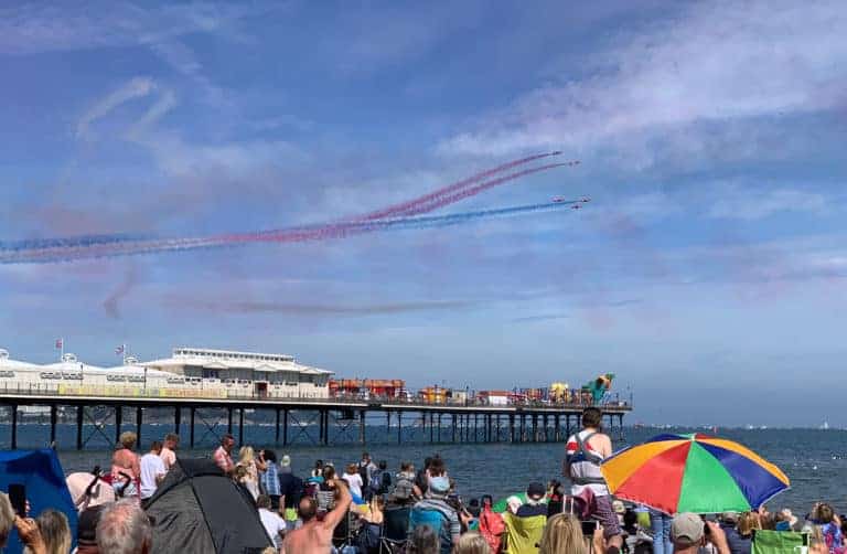 Red arrows flying past Paignton Beach during The English Riviera Airshow in Devon