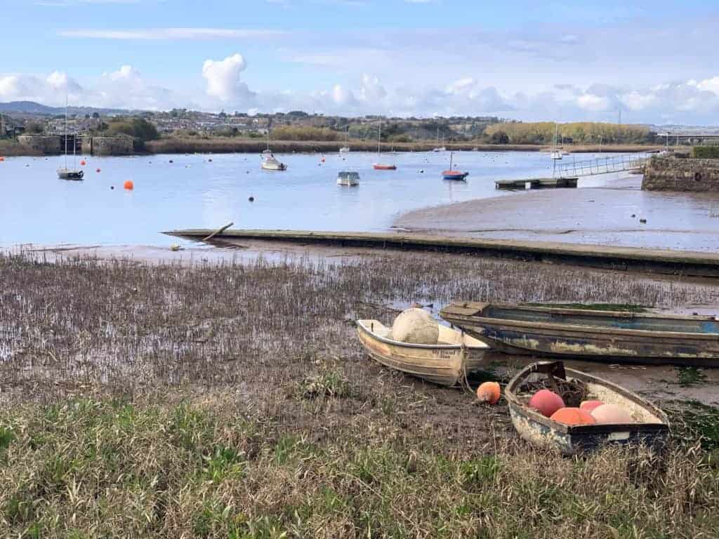 Fishing boats sit on the edge of River Exe at Topsham