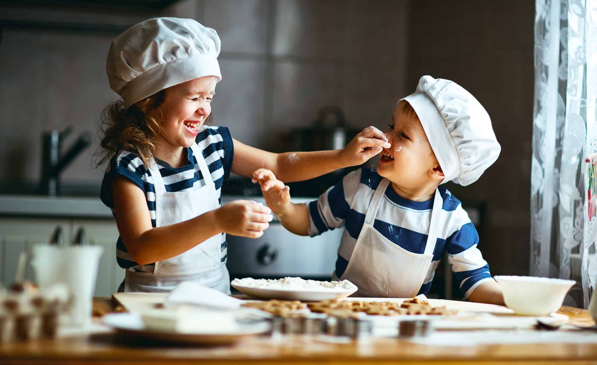 Happy kids baking a Devon recipe in their kitchen