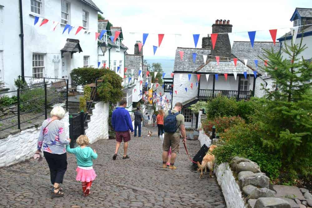 Family walking down cobbled hill in the North Devon fishing village of Clovelly