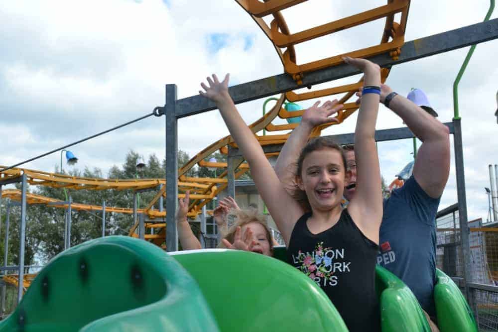 Kids on the Cosmic Caterpillar rollercoaster at The Milky Way theme park in North Devon