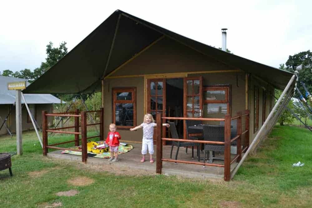 Children outside safari tent style glamping at Crealy Meadows in Devon, England