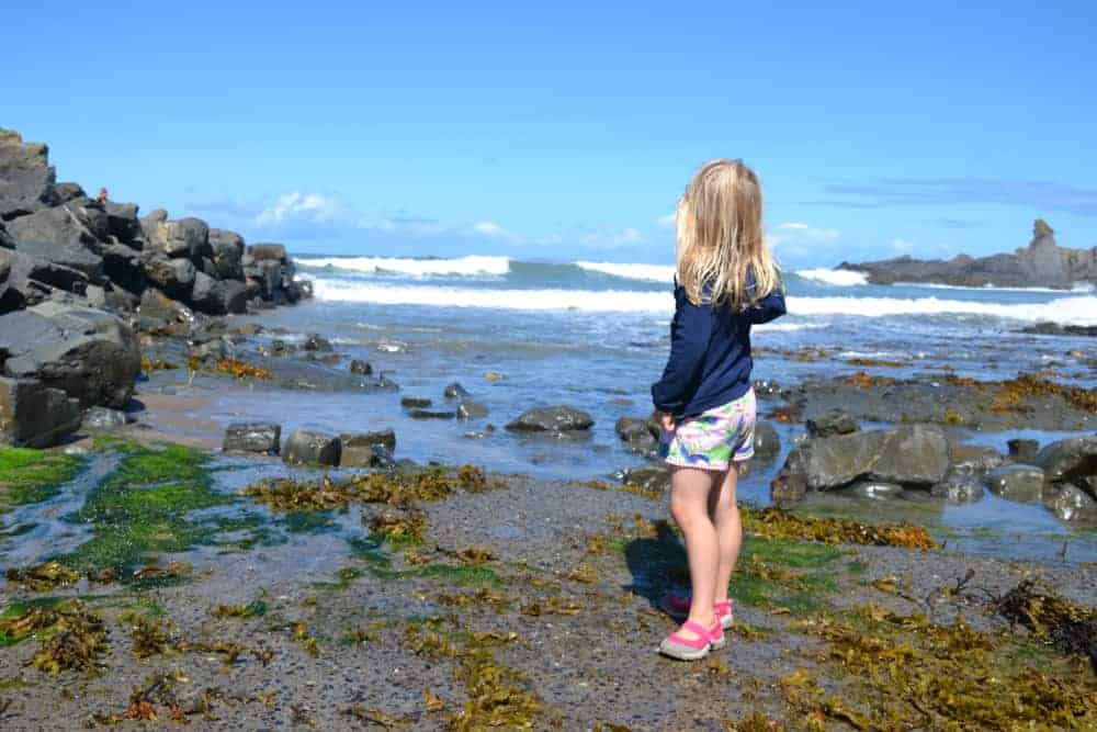 Girl standing on beach at Hartland Quay in North Devon