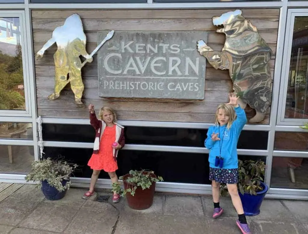 Children pretend to be cave bears outside Kents Cavern caves in Torquay