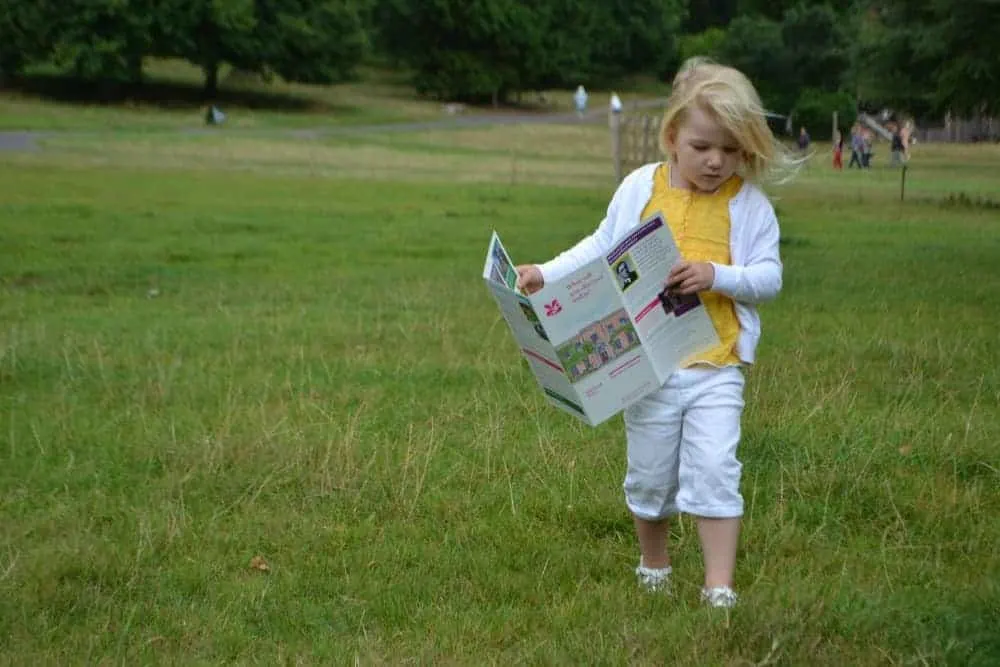Child carrying guide to Killerton across parkland
