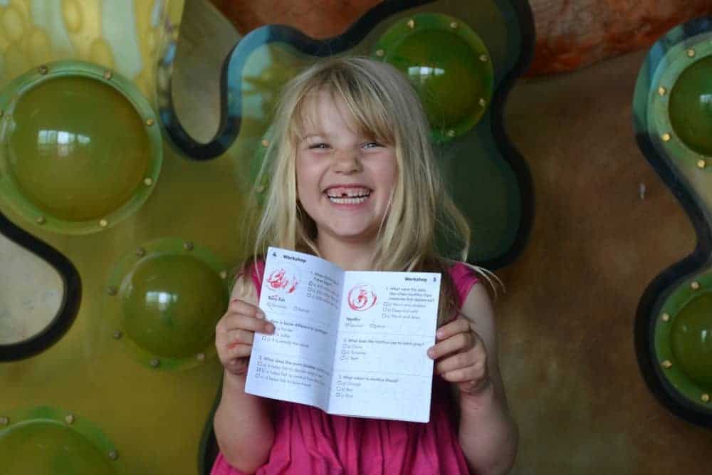 Child holding trail card at Seaton Jurassic attraction in East Devon