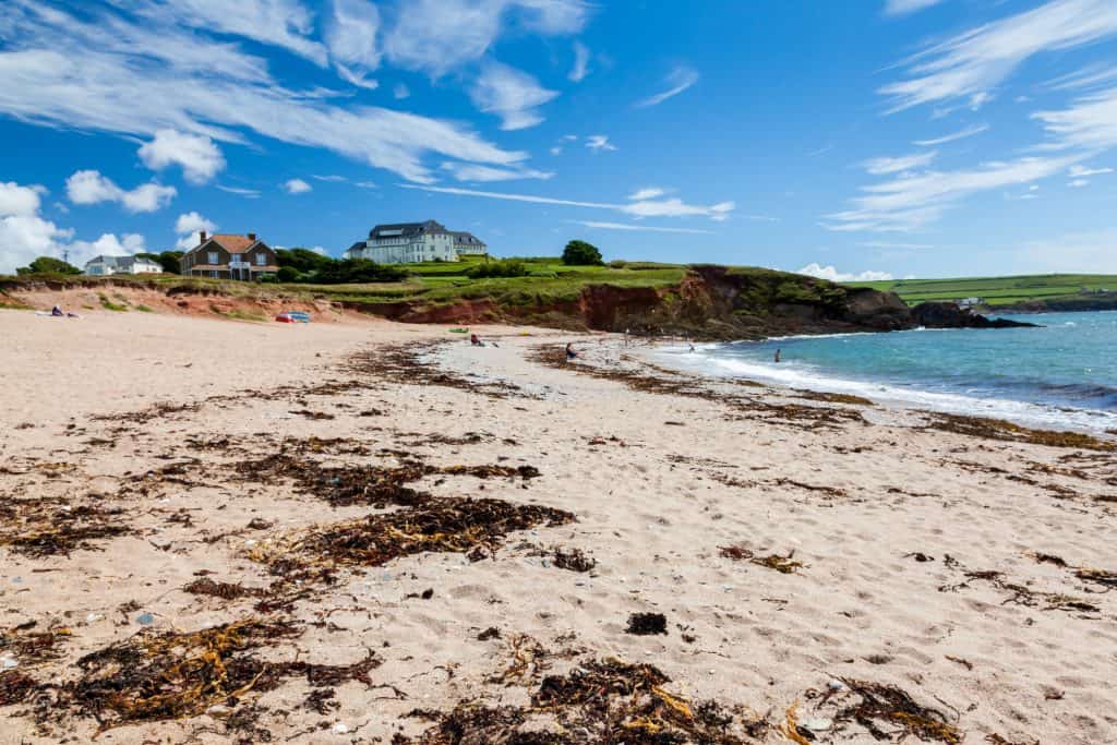The golden sandy Leas Foot Sands Beach at Thurlestone Devon with Thurlestone Hotel in background