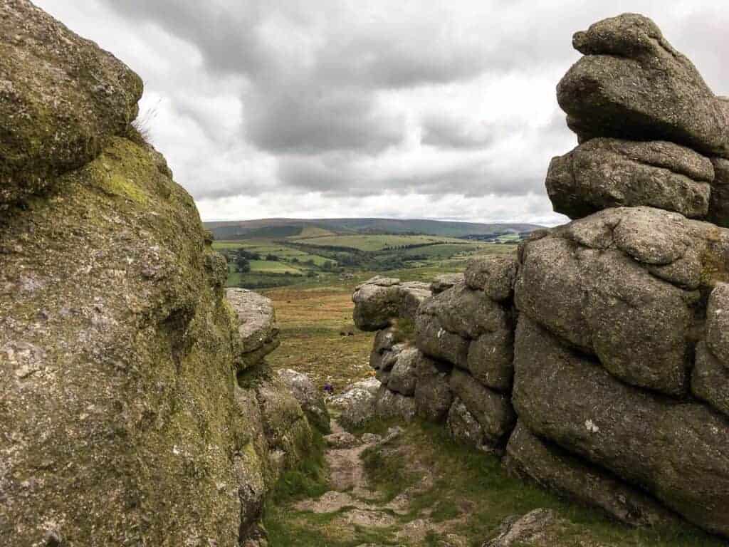 View from Haytor through granite stones - one of many places to go for walks on Dartmoor
