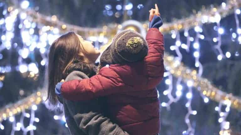 Woman and child looking at Christmas illuminations