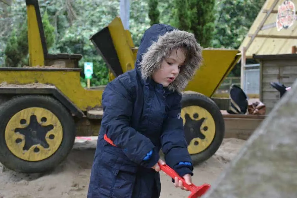 Child digging in sand pit