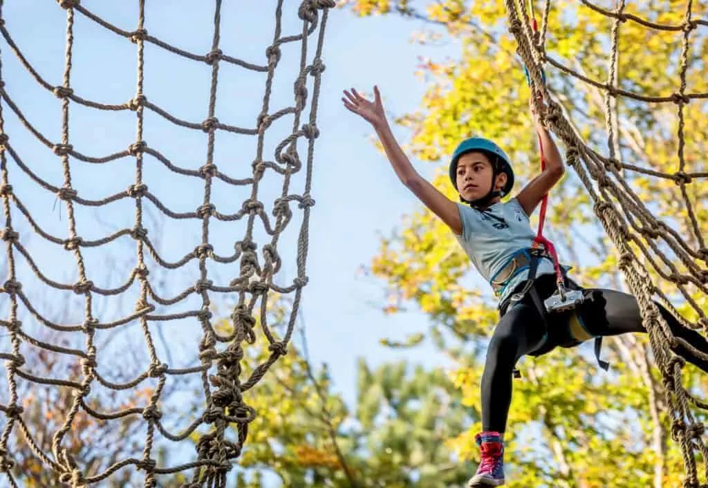 Teen on high ropes course