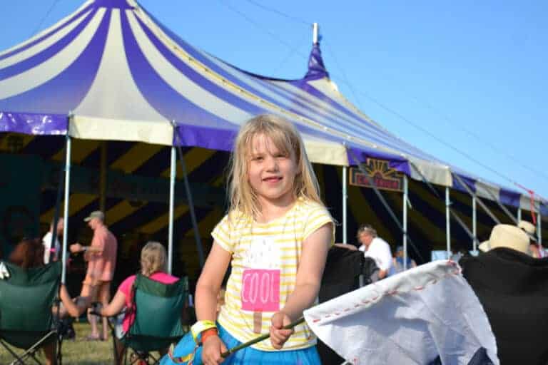 Child waving flag at festival in Devon