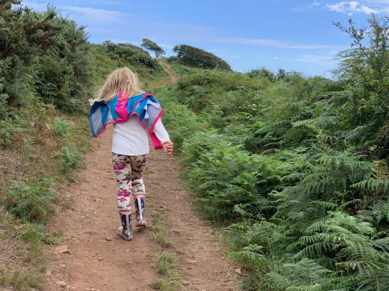Child walking along South West Coast Path in Devon