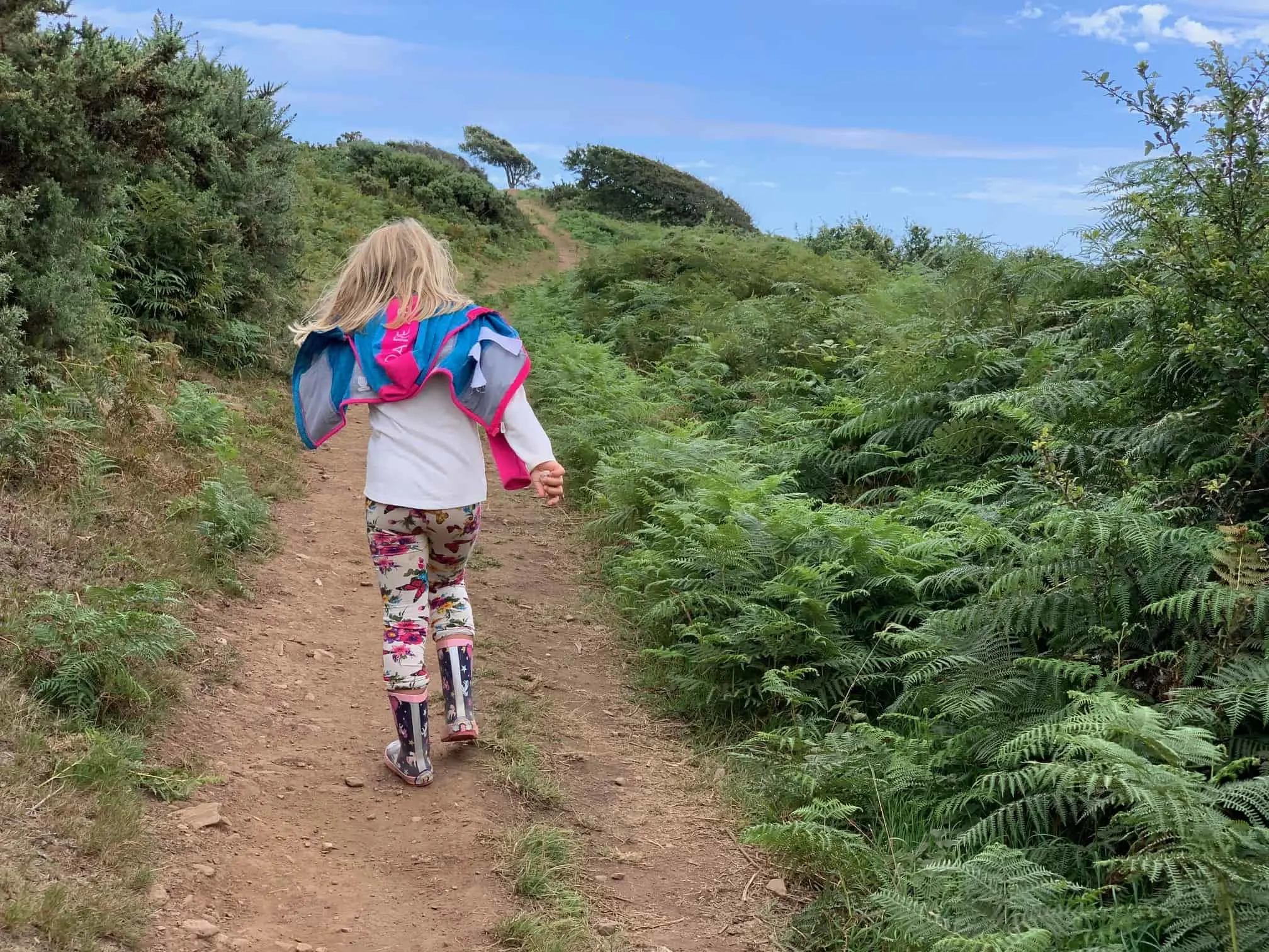Child walking along South West Coast Path in Devon