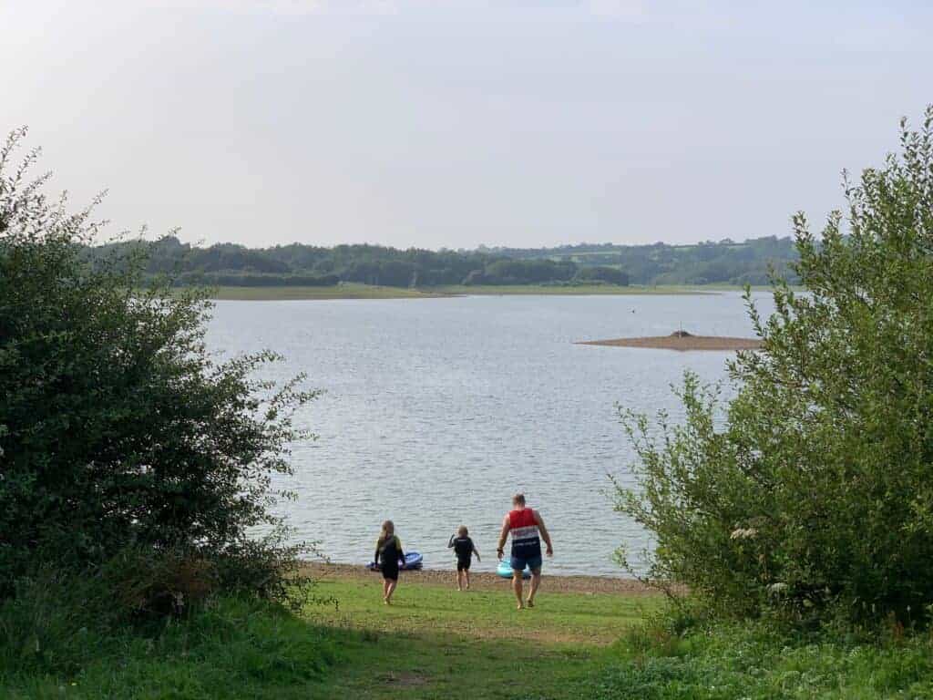 Family walking towards Roadford Lake