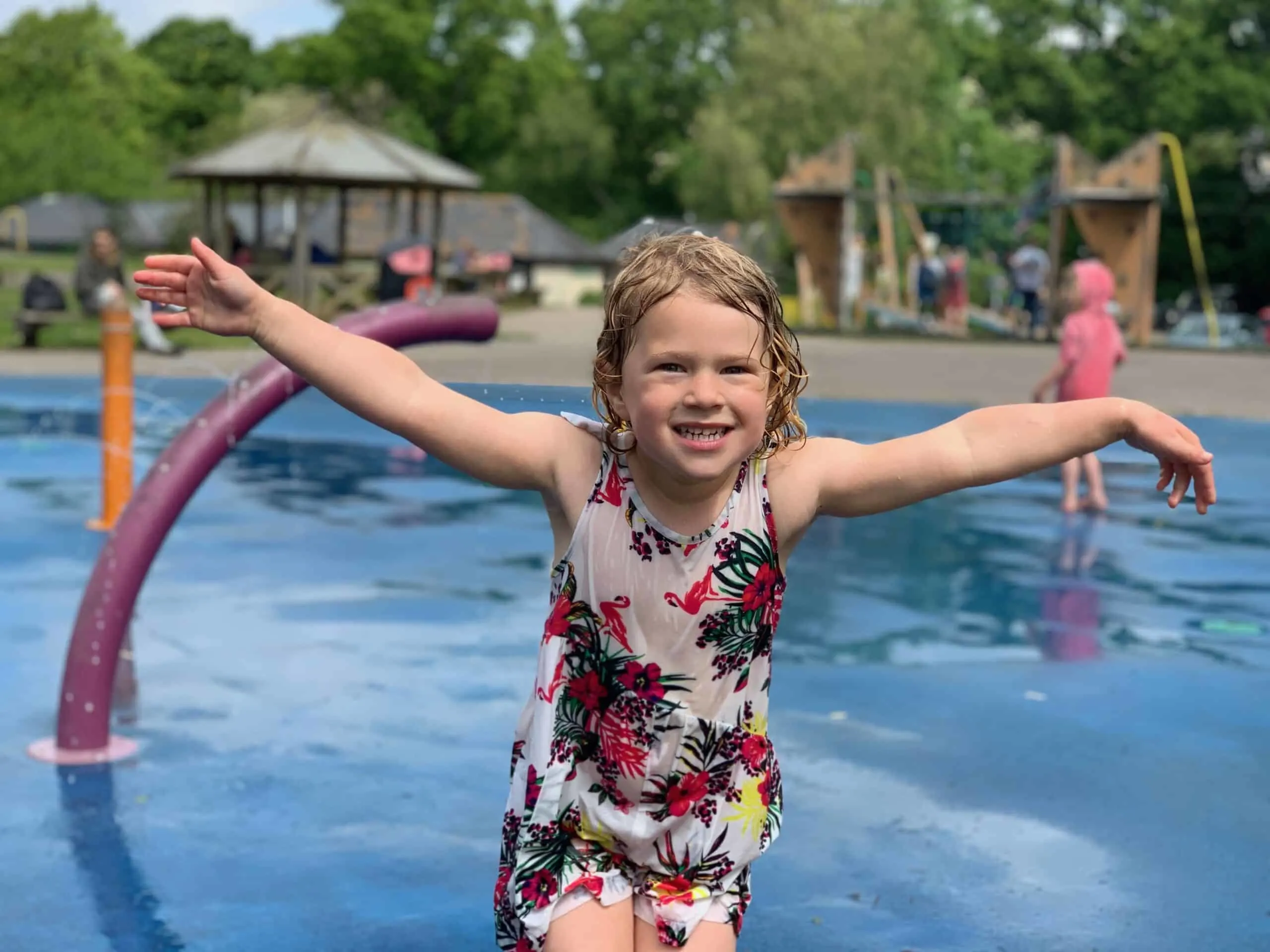 Child in splash park at Decoy Country Park adventure playground in Devon