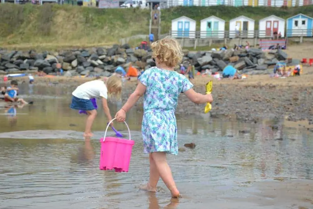 Child with bucket and spade on Summerleaze Beach in Bude