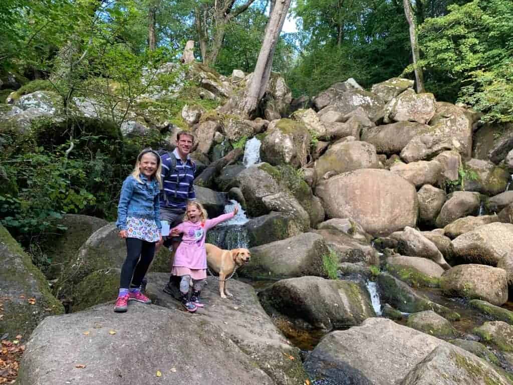 Family at Becky Falls waterfall in Dartmoor National Park