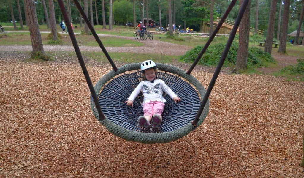 Child in bucket swing at Haldon Forest Park
