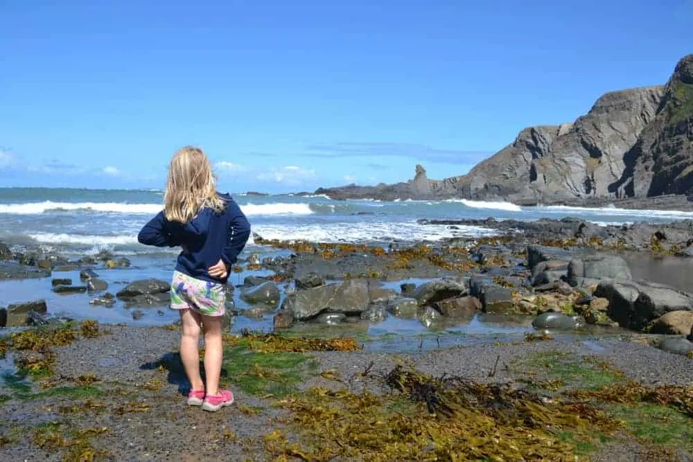 Girl stood at Hartland Quay beach