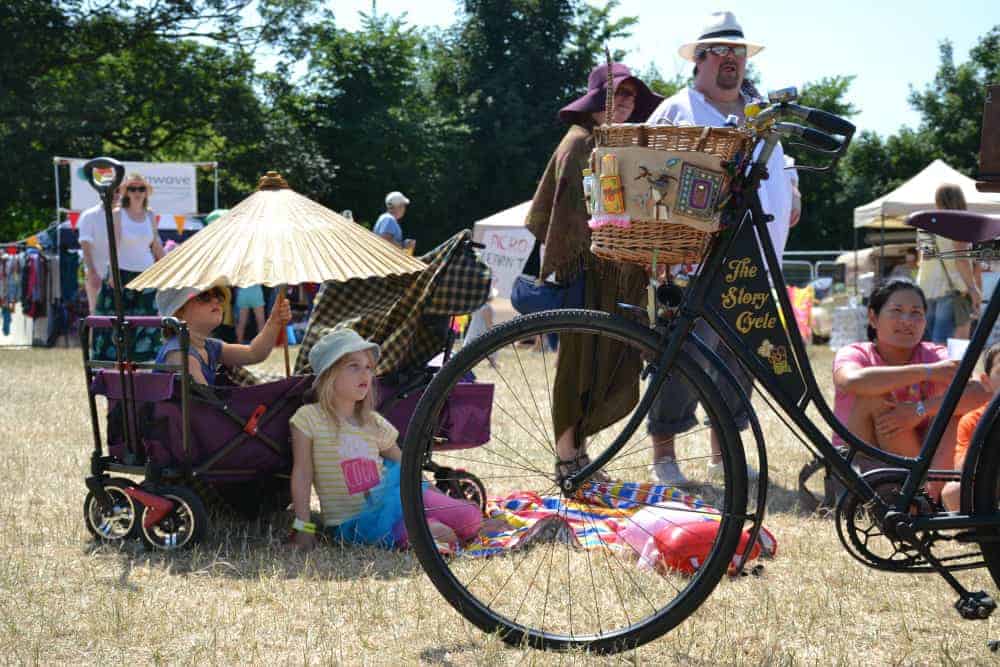 Children listening to story by the Story Cycle at Glas-Denbury festival in Devon