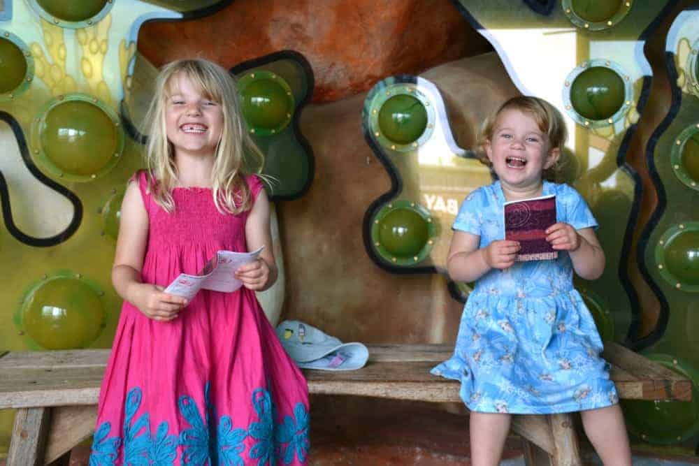 Sisters holding trail cards at Seaton Jurassic family attraction in Devon