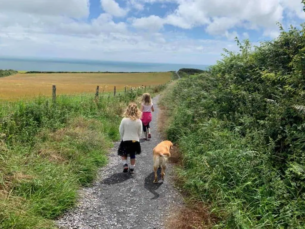 Children and dog walking down path out of Little Dartmouth car park