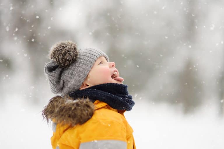 Boy catching snow on tongue
