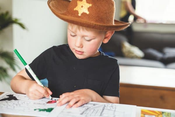 Child wearing hat colouring Devon Colouring Book for Kids