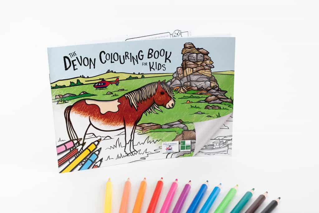 Devon Colouring Book for Kids cover with pencils fanned out below