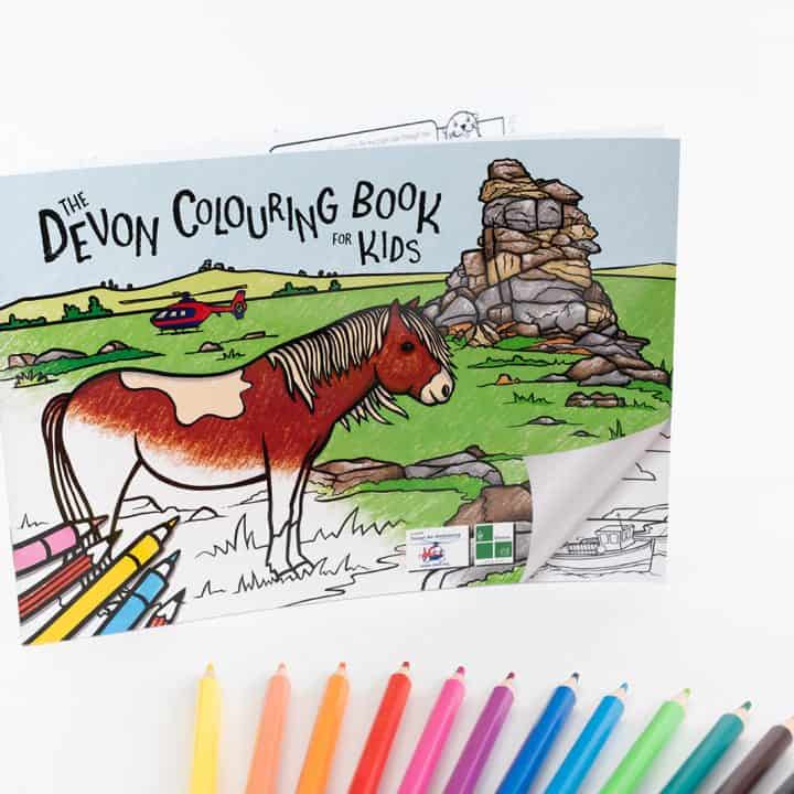 Devon Colouring Book for Kids cover with pencils fanned out below