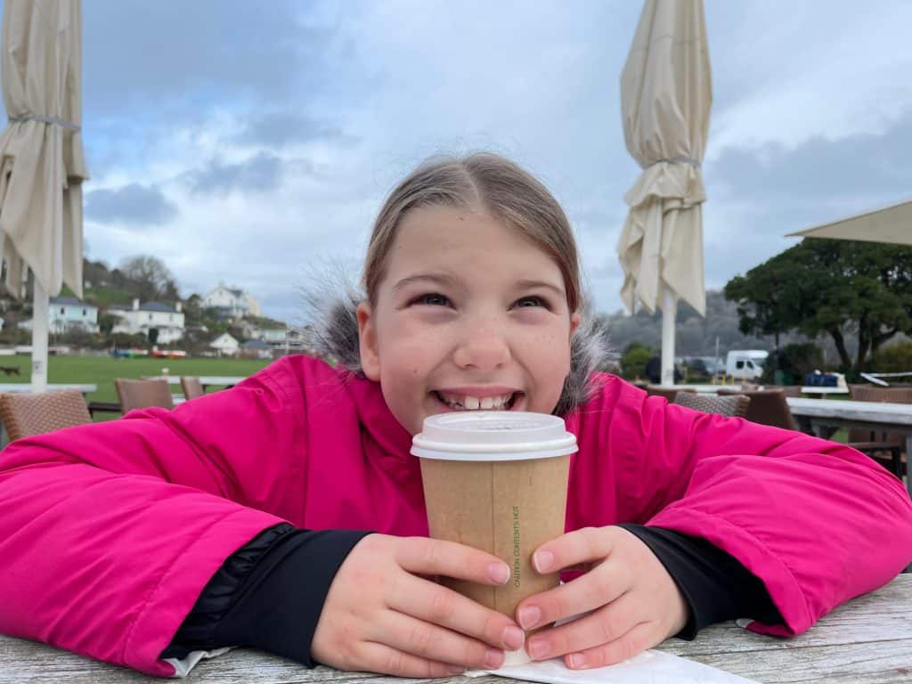 Girl drinking hot drink and outdoor cafe