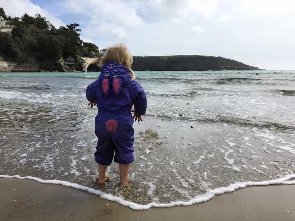 Toddler paddling on North Sands Beach in South Devon