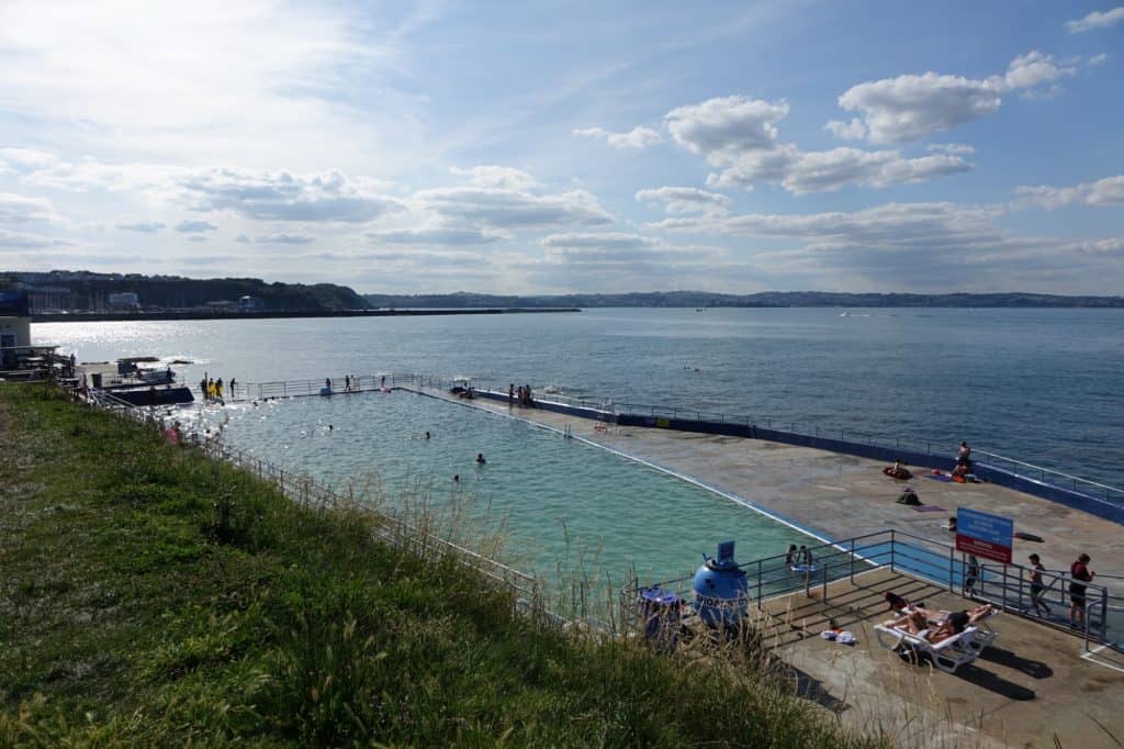 Beautiful Brixham seascape with the outdoor swimming pool in a sunny Brixham Devon looking out to sea