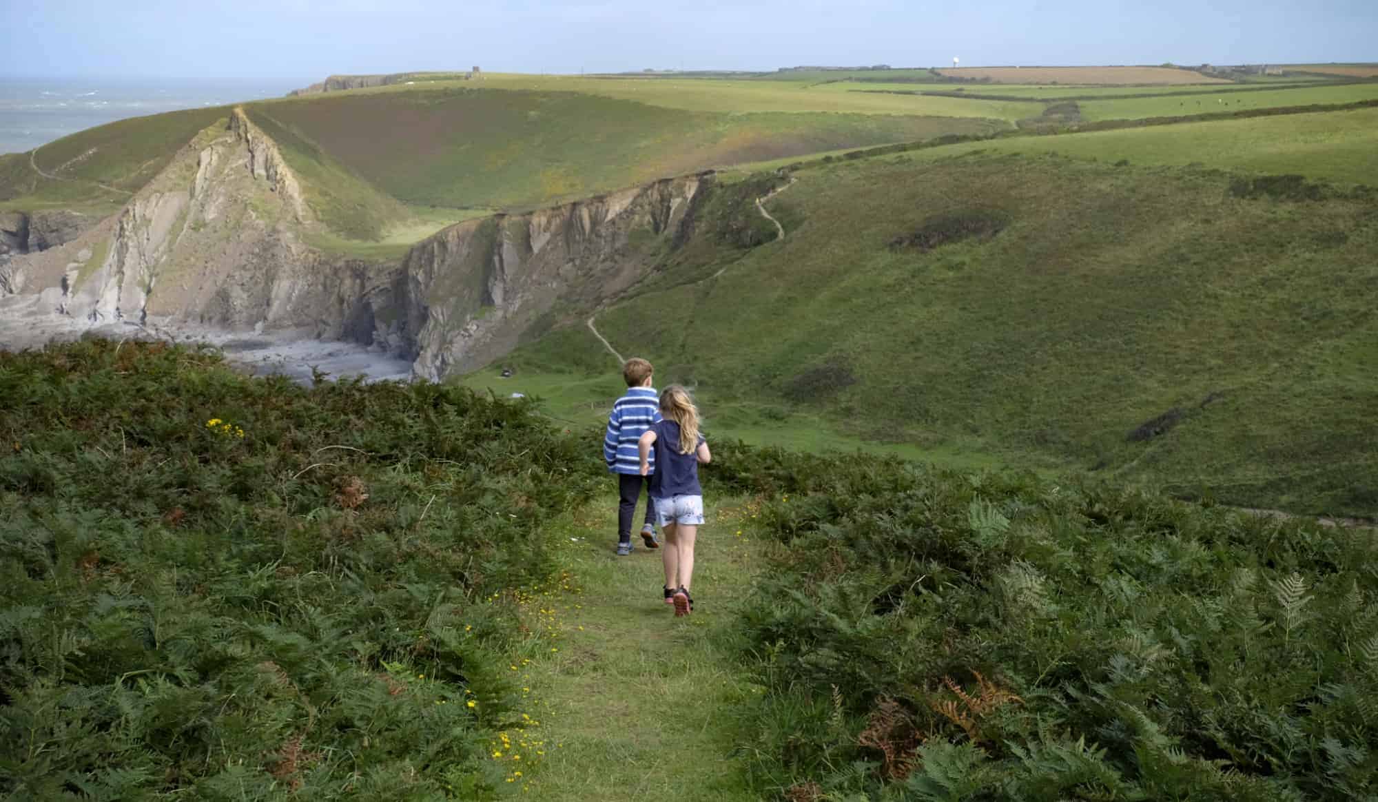 Children walking on the coastal path at Hartland, North Devon.