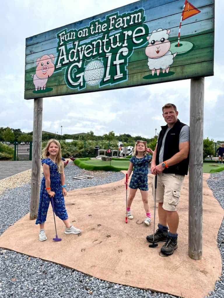 Family at start of adventure golf at Crealy Meadows campsite