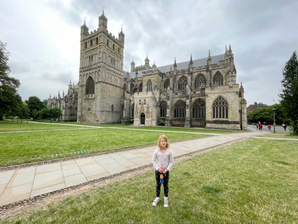 Child stood on Exeter Cathedral Green