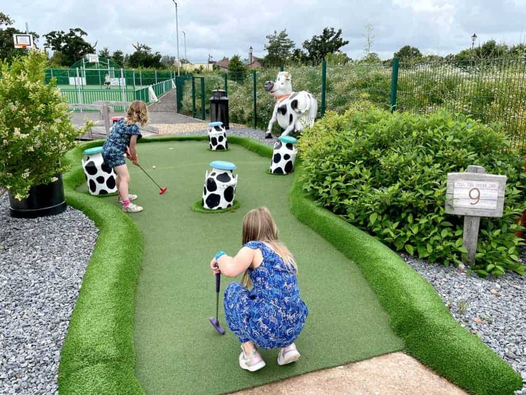 Family at start of adventure golf at Crealy Meadows campsite