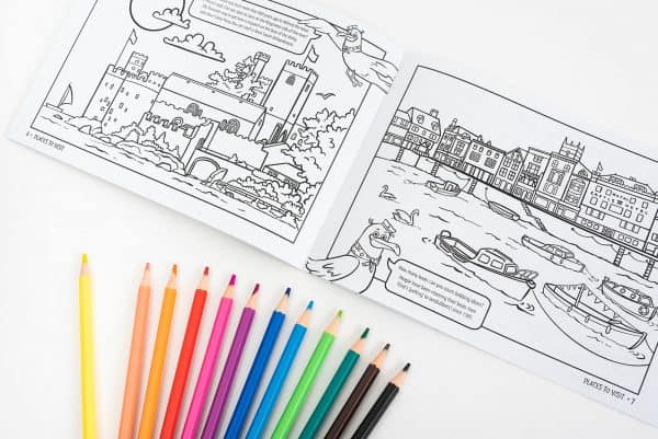 Page of the Dartmouth Colouring Book for Kids open with pencils fanned out below