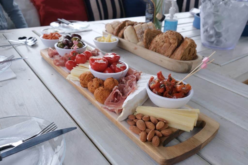 Platters of cheese, cold meats, olives and bread