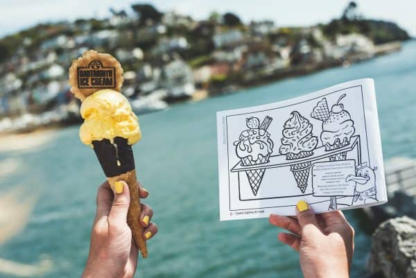 Hands holding an ice cream and colouring page with ice cream illustration