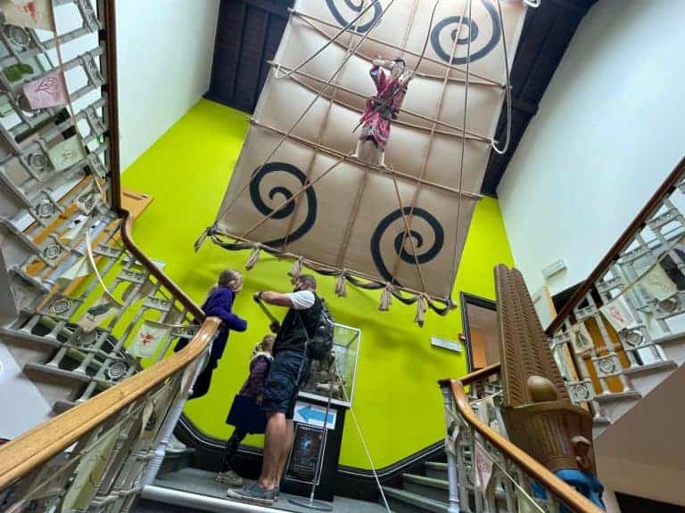 Family on stairwell at Torquay Museum under Japanese Man Kite