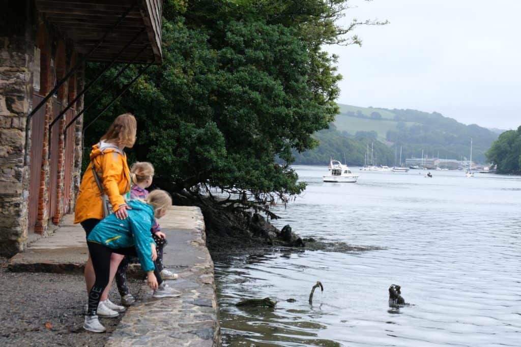 Family looking down River Dart next to the Greenway Boathouse