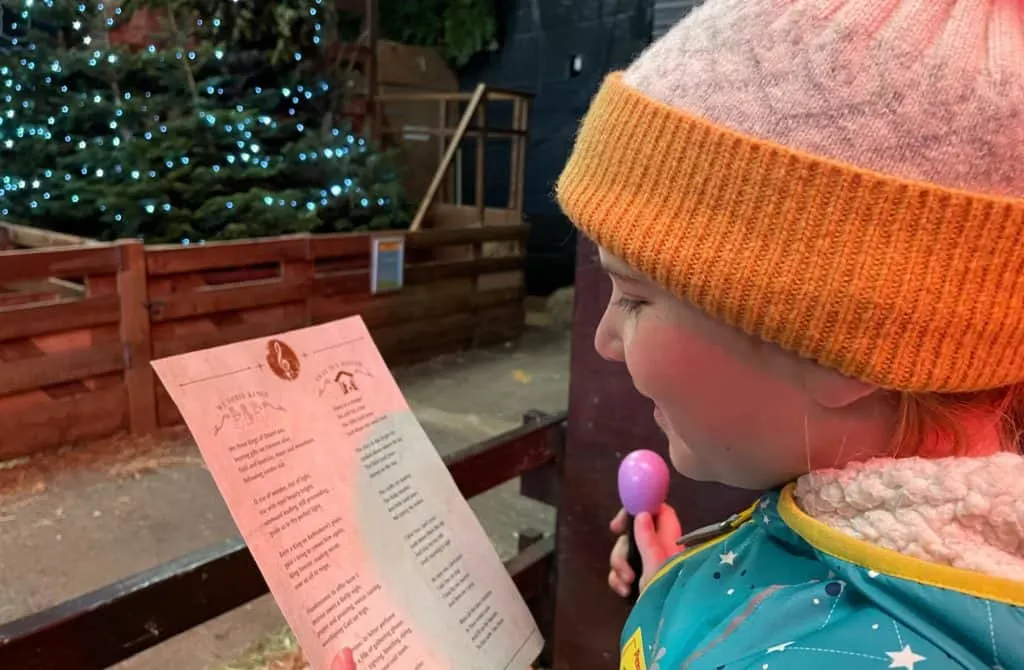 Child reading carol sheet